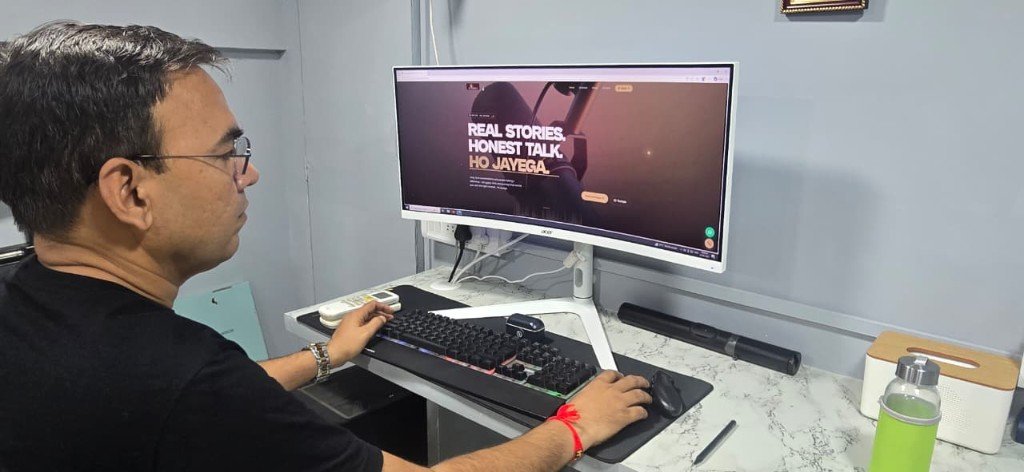 Dr. Dilip Pal at his desk with the Ho Jayega website on screen