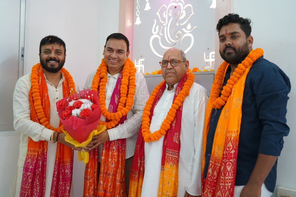 Team at a ceremonial inauguration with marigold garlands